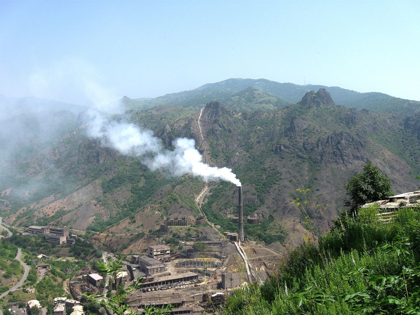 The copper smelter chimney smoking above Alaverdi's Soviet-era buildings in the Debed canyon