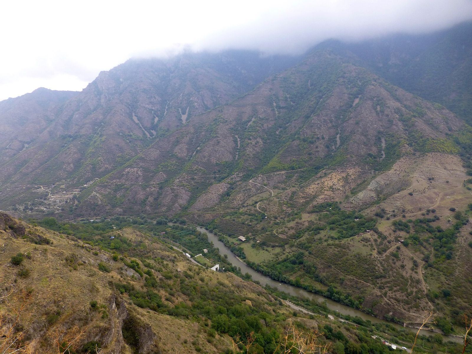The Debed River winding through a steep, wooded canyon in northern Armenia under low cloud