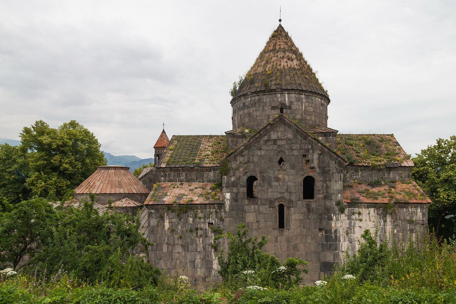 The main stone church of Sanahin Monastery among green trees in northern Armenia