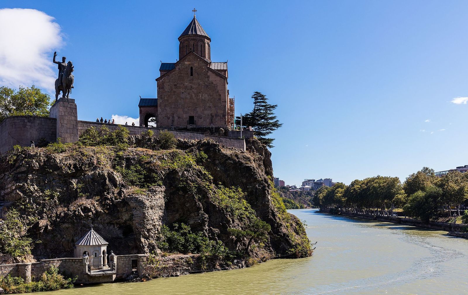 Metekhi Church on its cliff above the Kura river with the statue of King Vakhtang Gorgasali on horseback and the small St Abo chapel at the water's edge