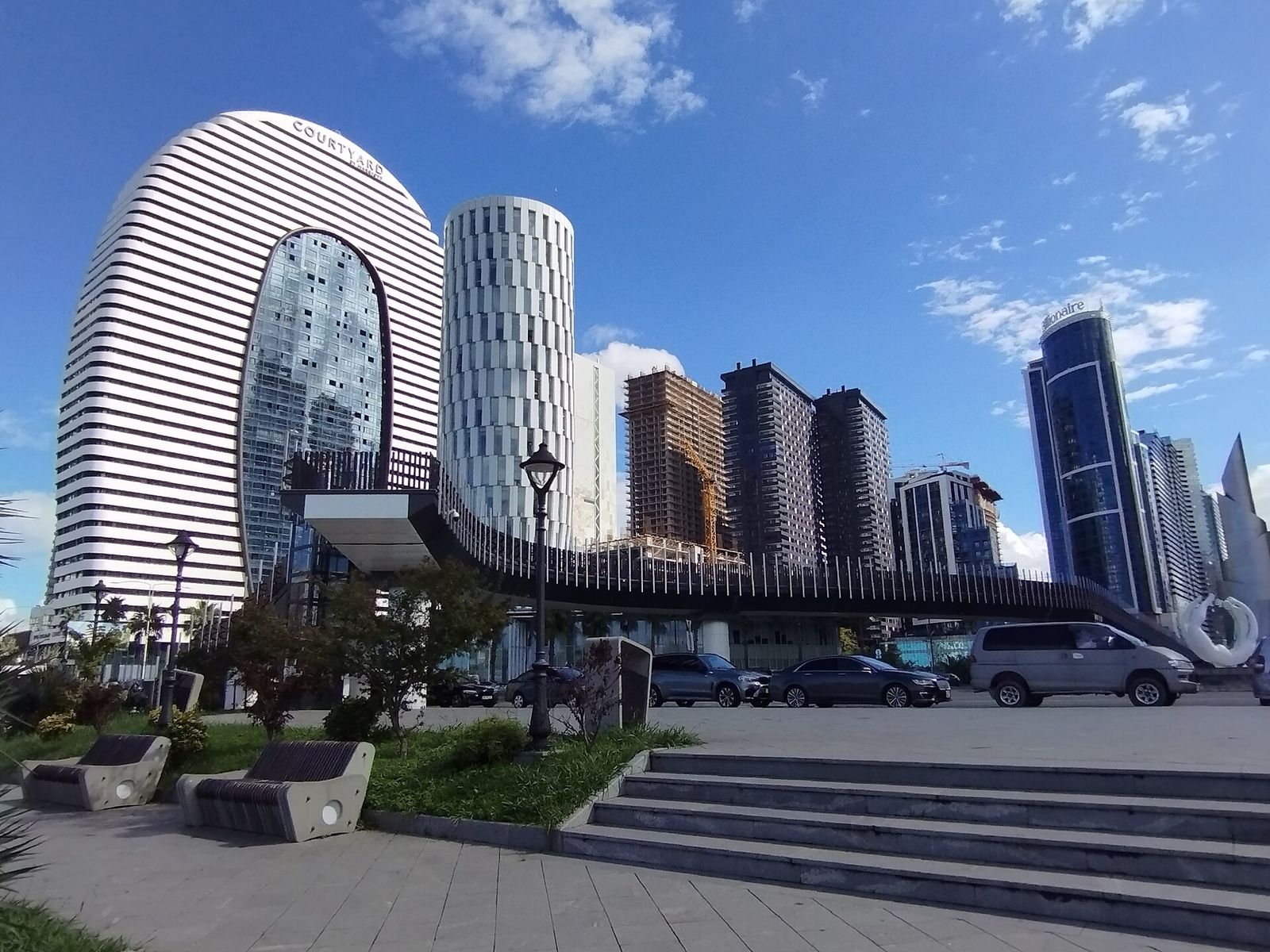 The glass and concrete towers of New Batumi rising behind the beach promenade
