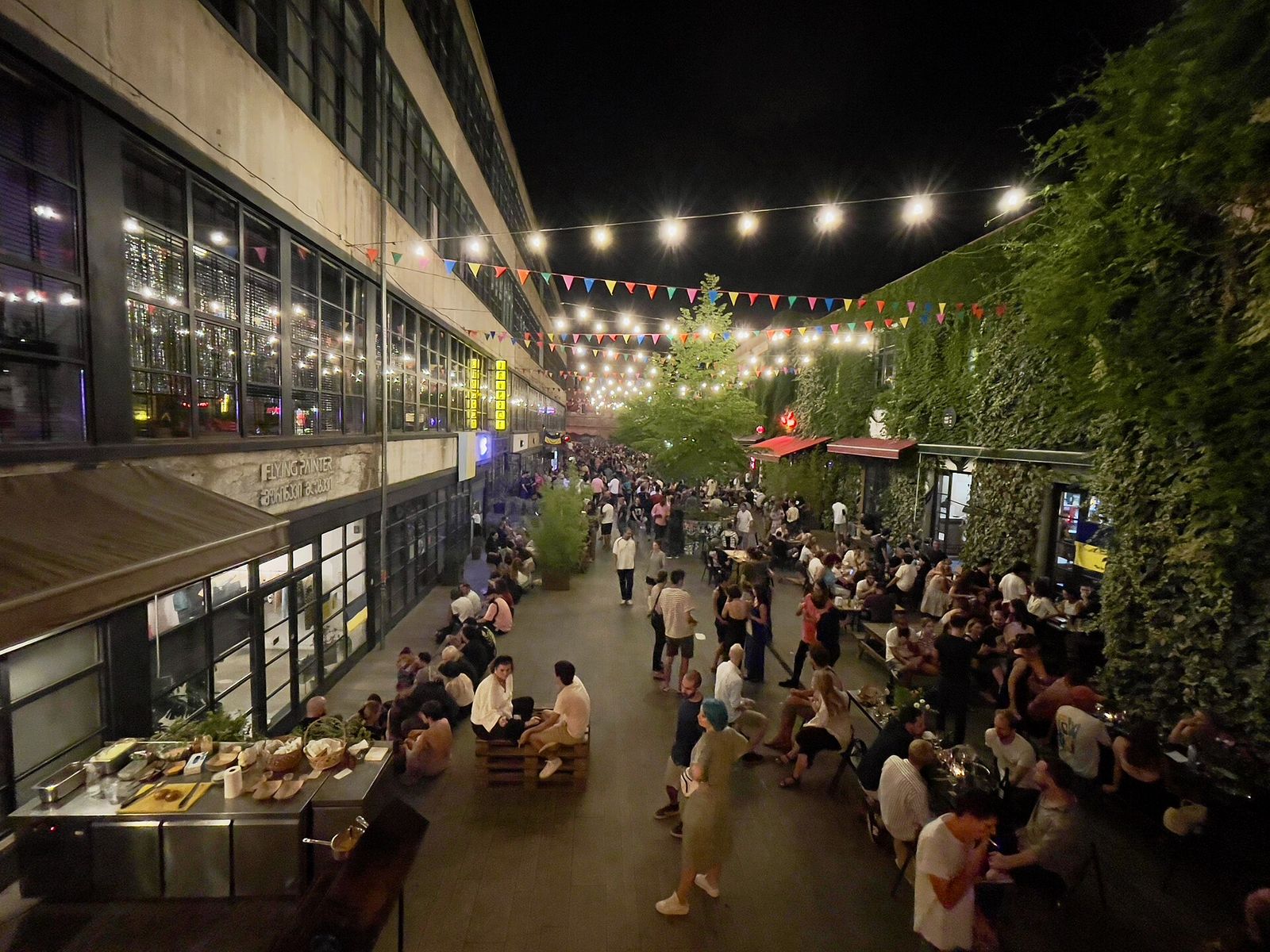 Fabrika's courtyard in Tbilisi at night, strung with lights and full of people at outdoor tables