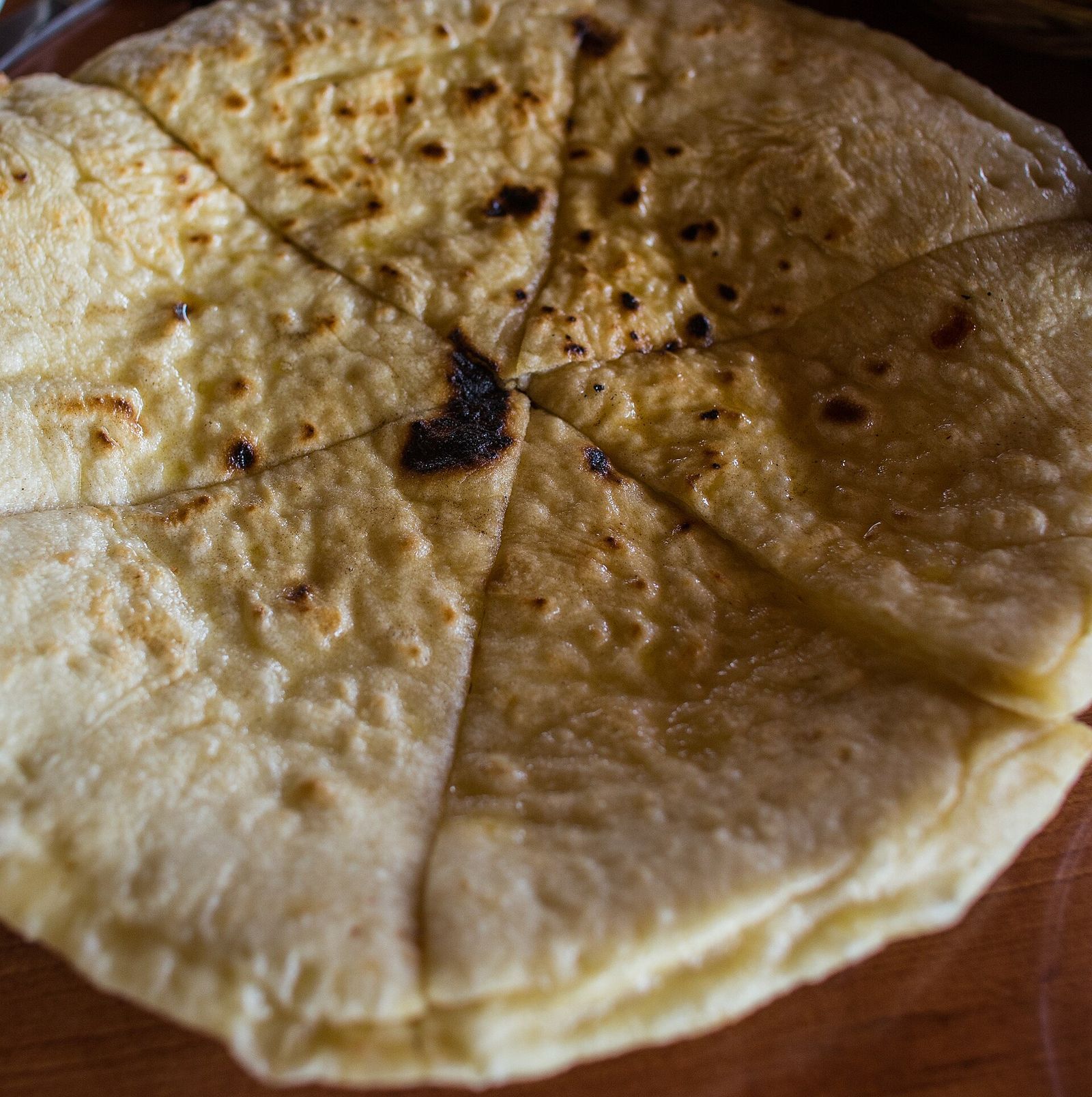 A round Imeruli khachapuri, with the cheese sealed inside, cut into slices