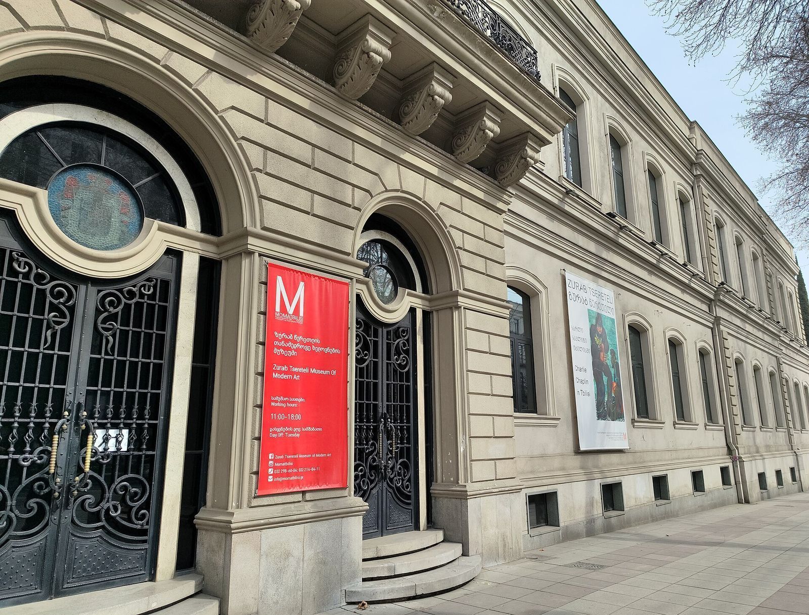 The entrance to MoMA Tbilisi, Zurab Tsereteli's Museum of Modern Art on Rustaveli Avenue, with its red M banner