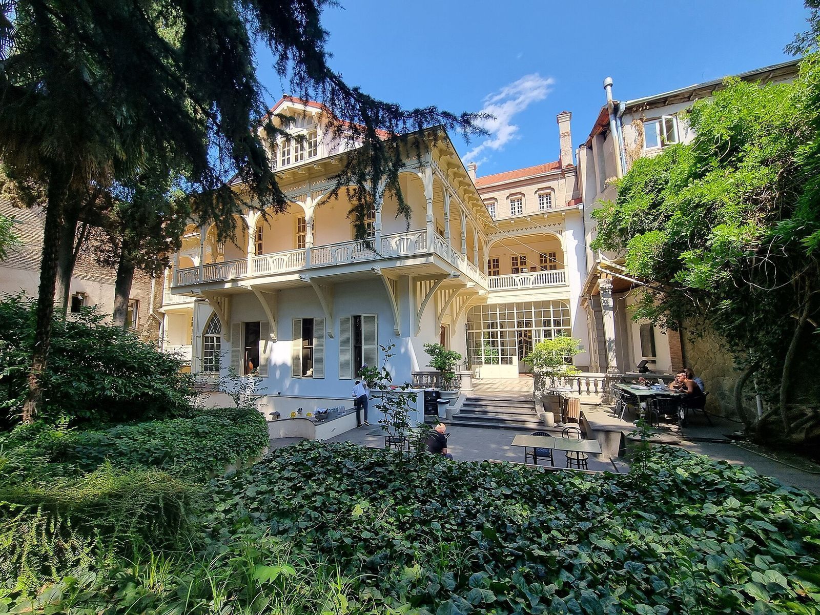The Writers' House of Georgia on Ivane Machabeli Street seen from its garden, with cafe tables under the trees