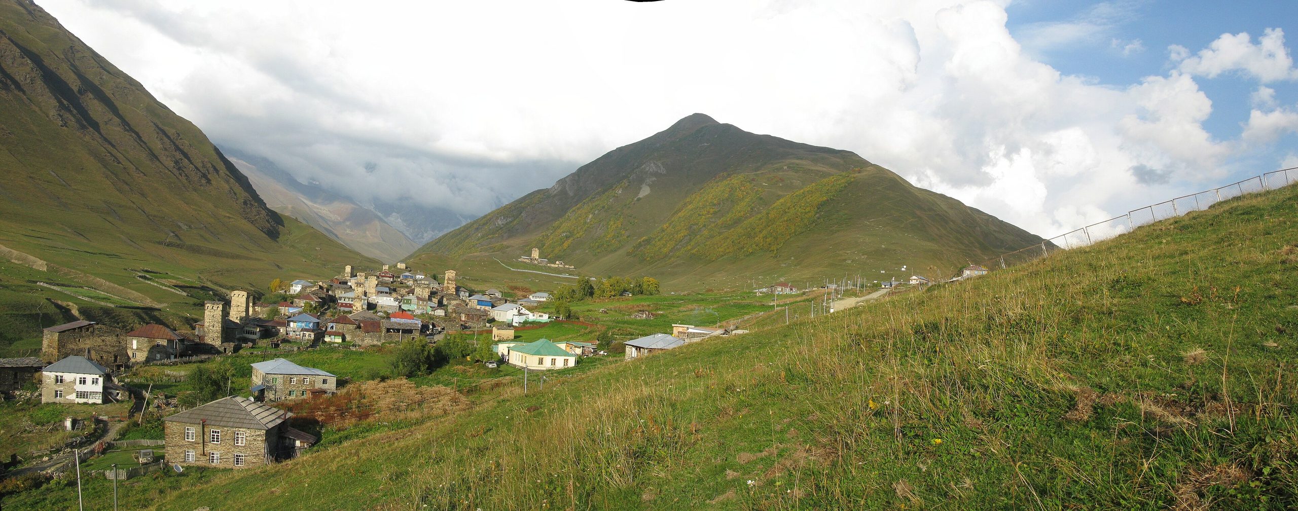 The village of Ushguli in Svaneti below a green mountain