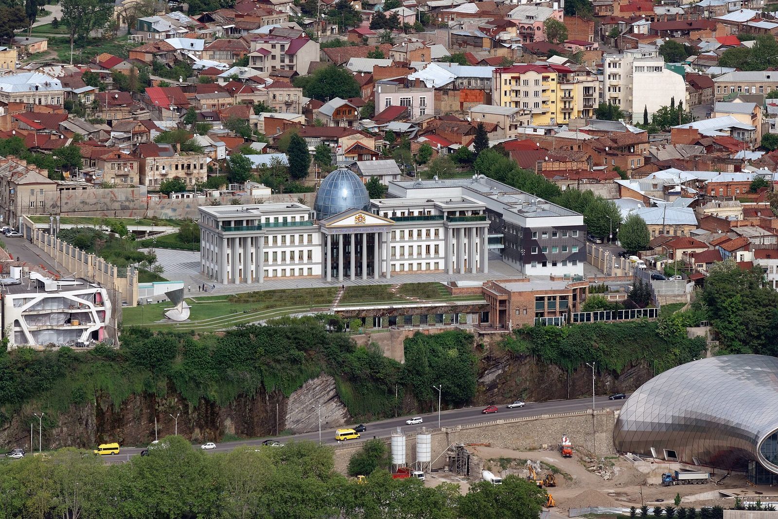 The old presidential palace in Avlabari, a white colonnaded building with a blue glass dome, above the river cliff