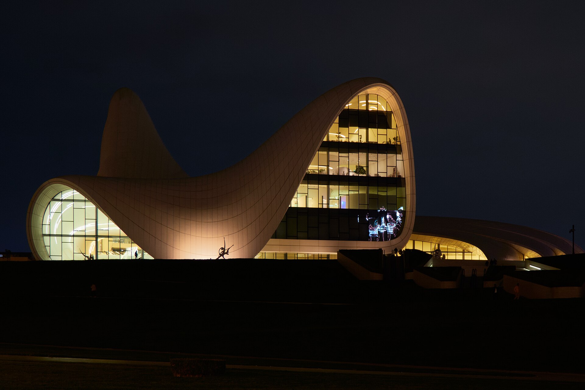 The white curving Heydar Aliyev Center in Baku, lit up at night