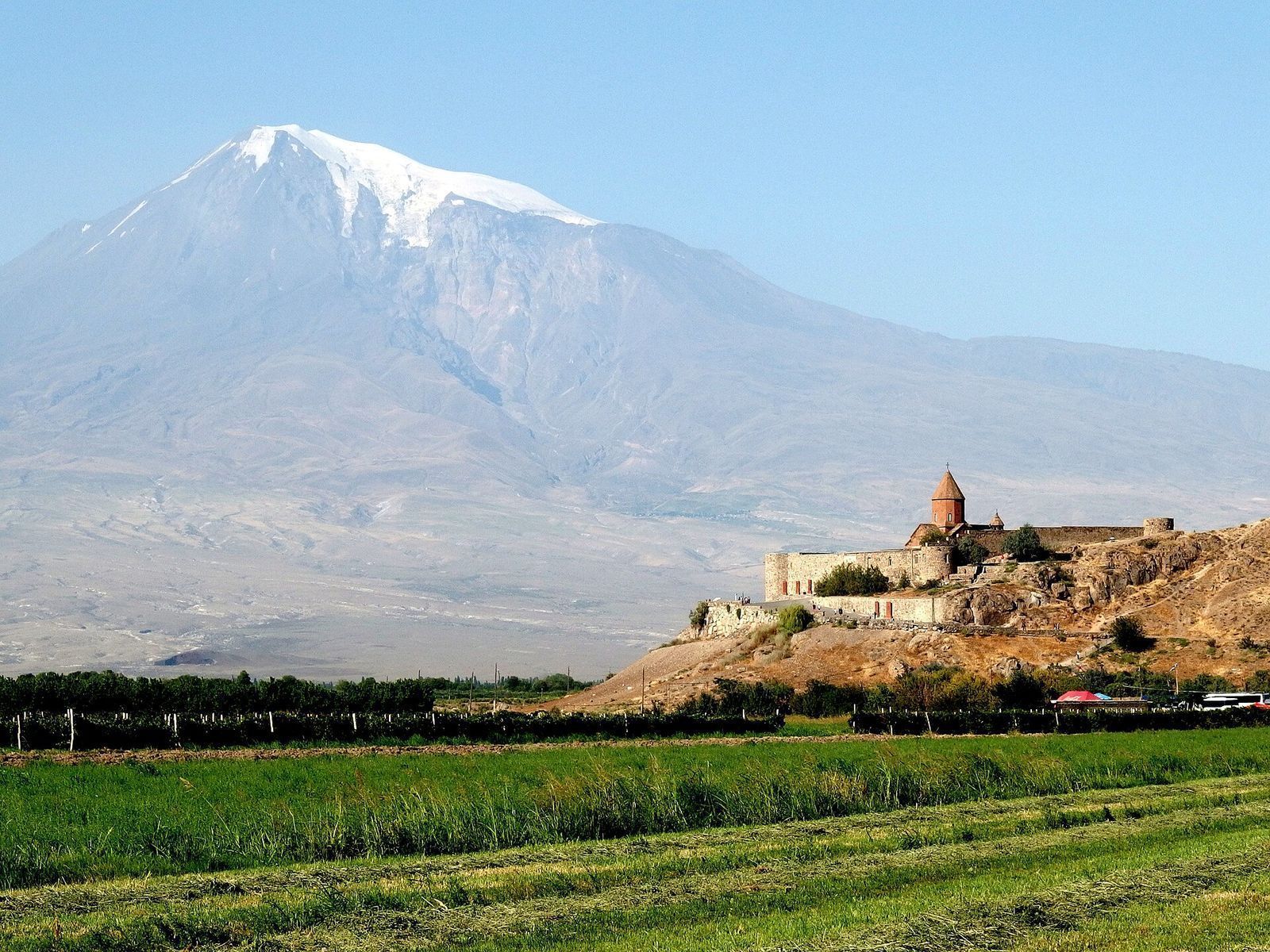 Khor Virap Monastery on its rocky hill, with snow-capped Mount Ararat behind