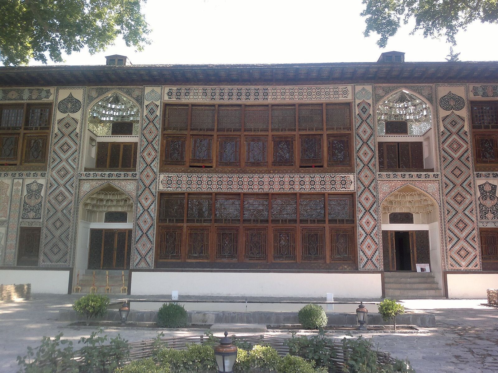 The painted facade and latticed stained-glass windows of the Khan's Palace of Sheki, Azerbaijan