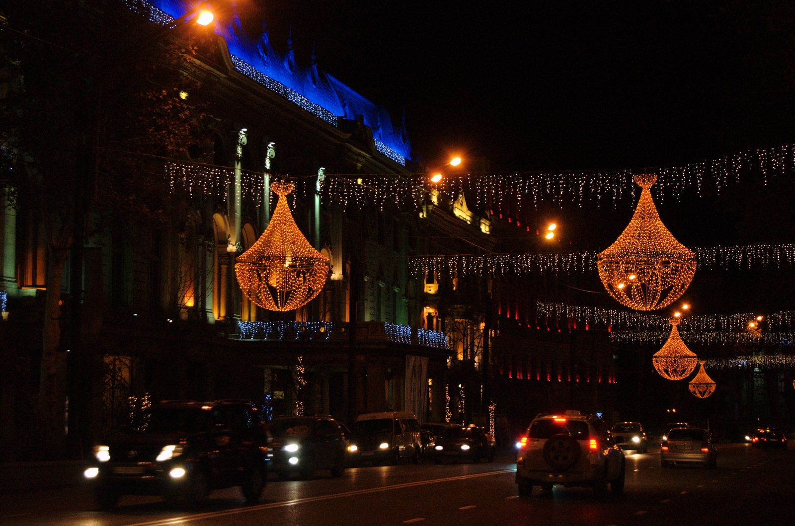 Strings of Christmas lights hanging over Rustaveli Avenue in Tbilisi at night