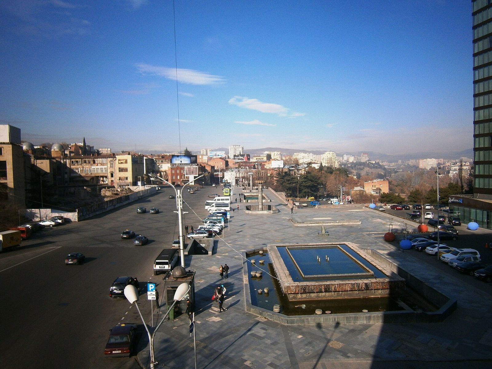 First Republic Square in Tbilisi on a clear January day, seen from above, with its fountain pools and the city beyond