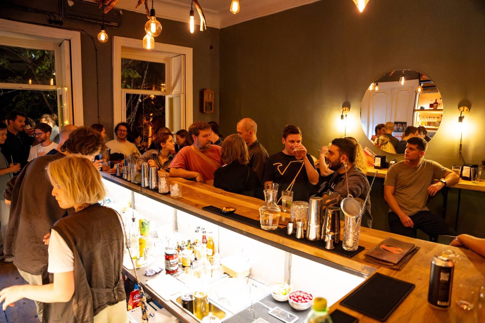 A packed Wednesday meetup at the bar of Crossroads Bar in Tbilisi, expats and locals talking over cocktails