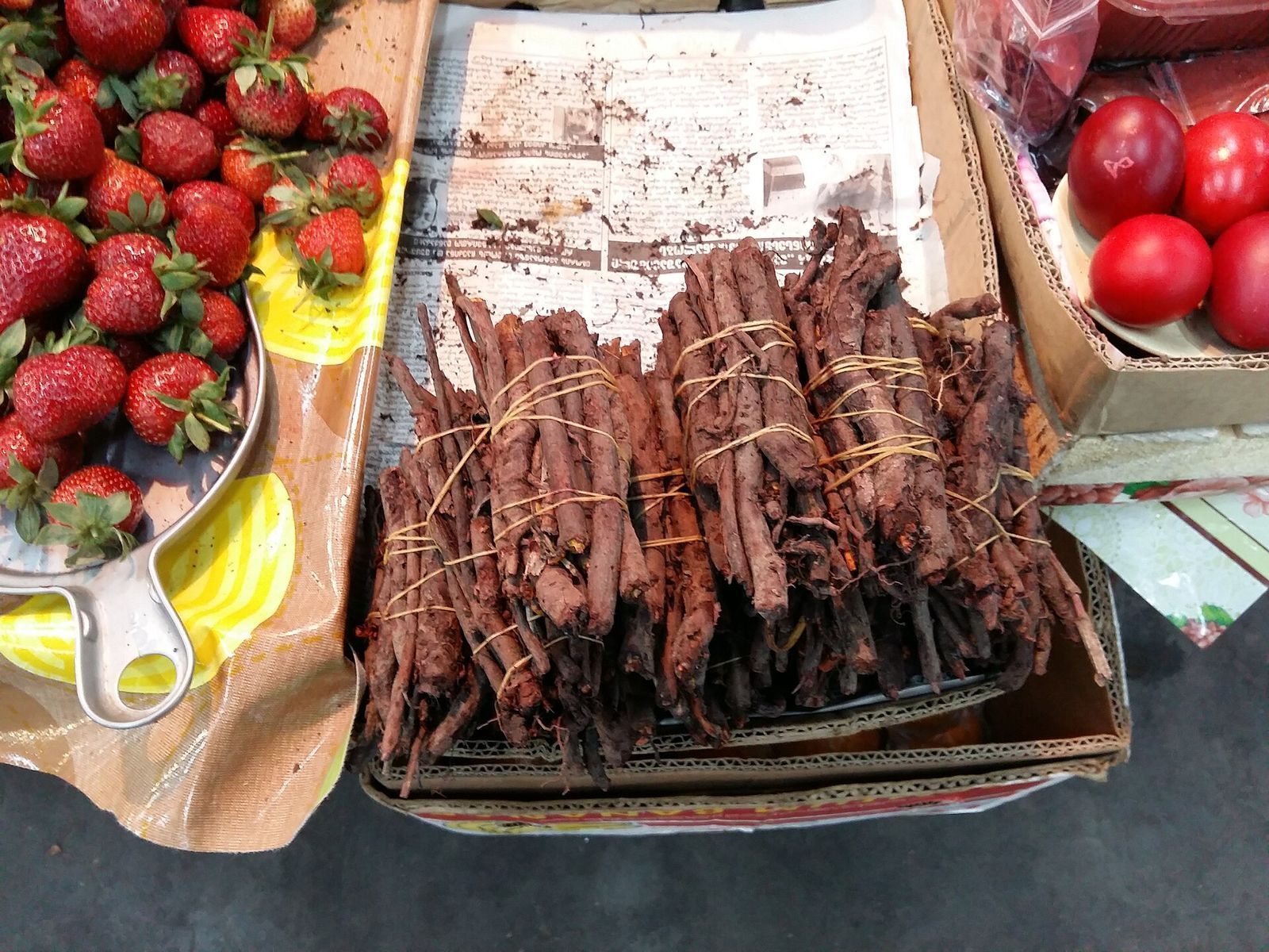 Bundles of dried madder root for sale at a market in Georgia, used to dye Easter eggs red
