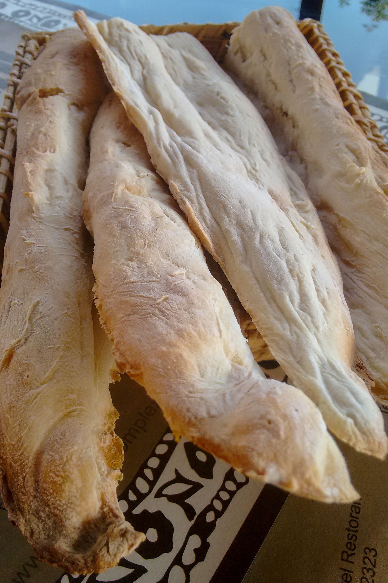 A basket of long shotis puri, the canoe-shaped Georgian bread, on a restaurant table