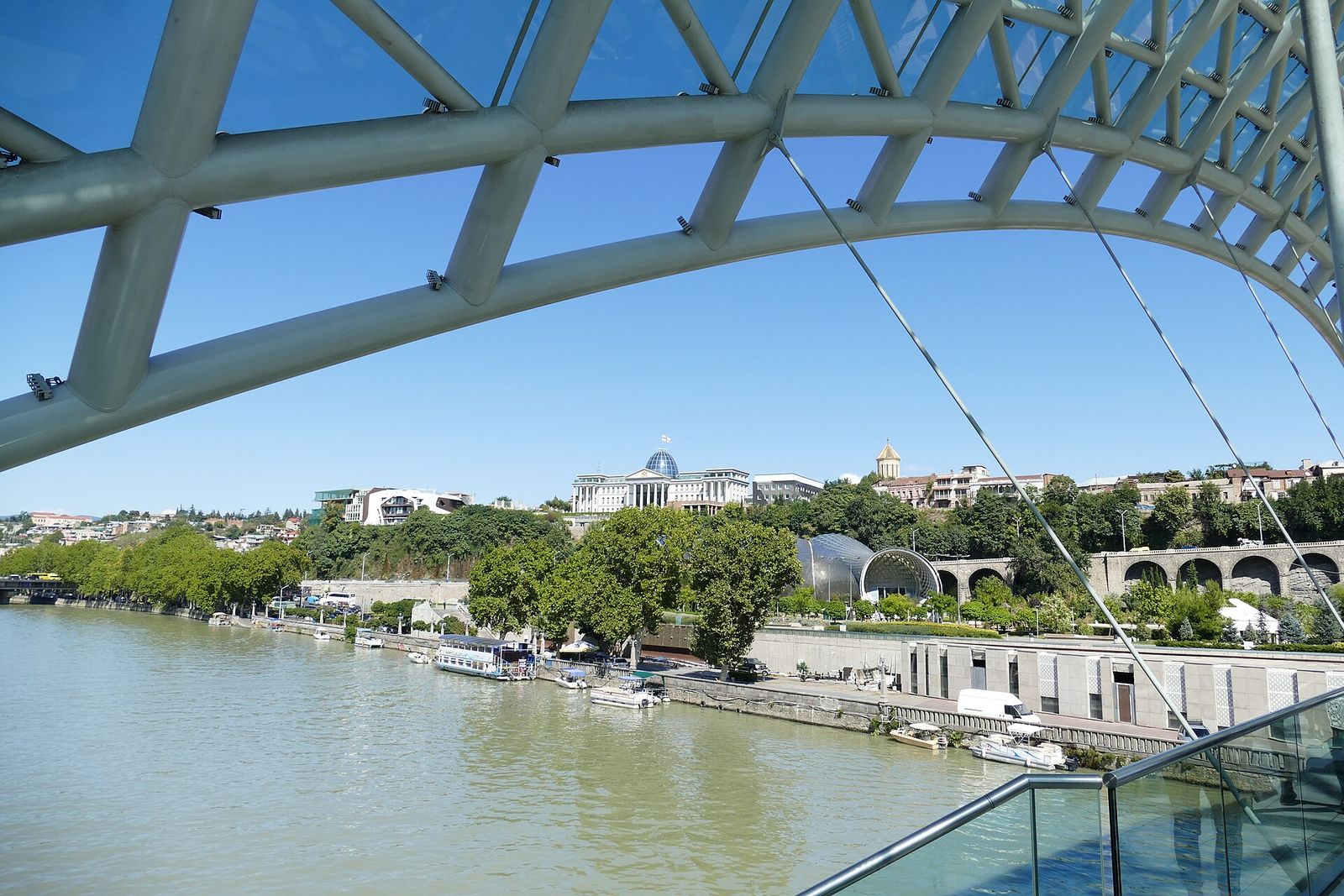 Rike Park and the Kura River seen through the arch of the Bridge of Peace, with the Presidential Palace on the hill above