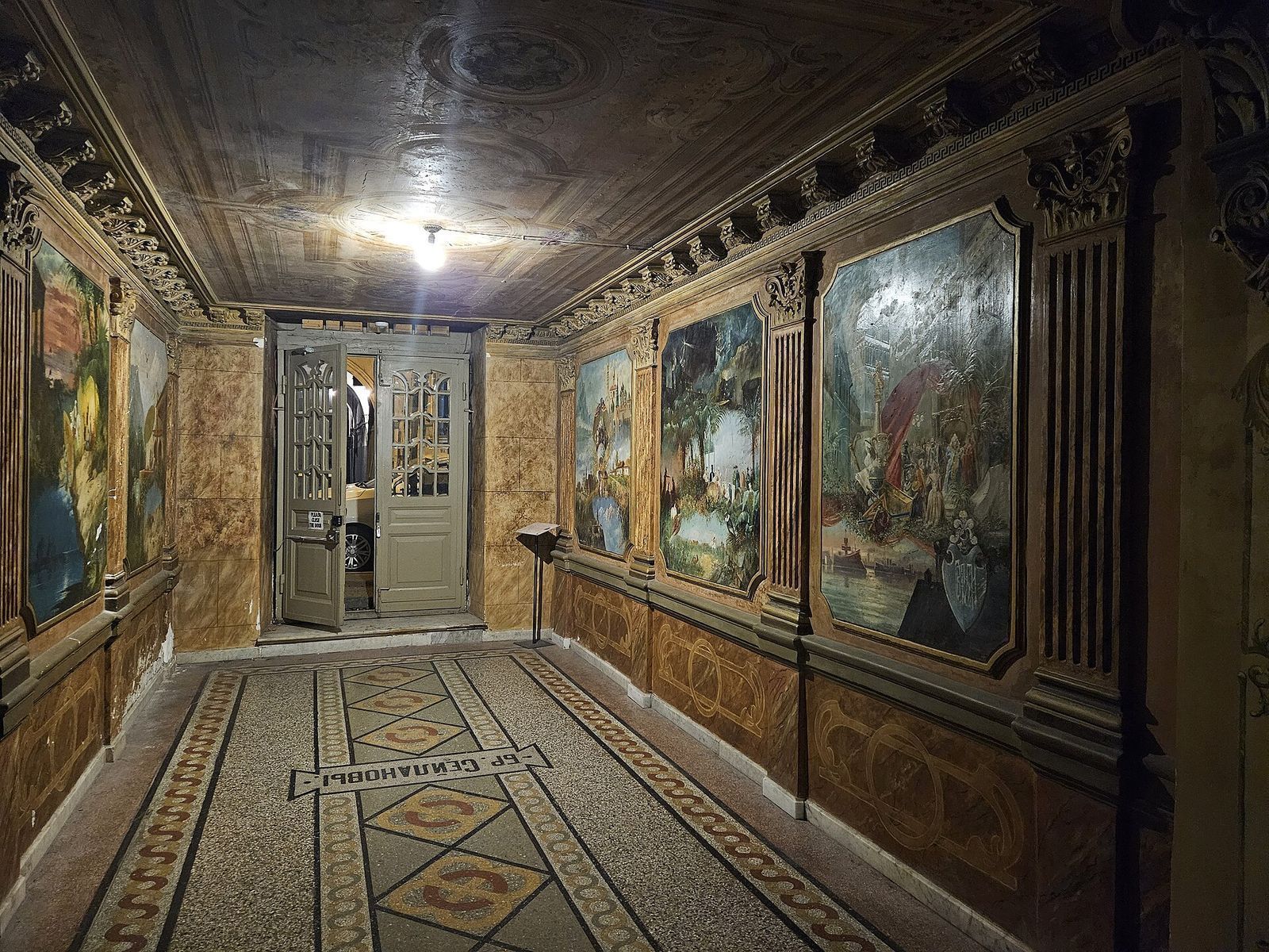 The restored foyer of the Seylanov house at Galaktion Tabidze Street 18 in Sololaki, with allegorical paintings on the walls and a mosaic floor