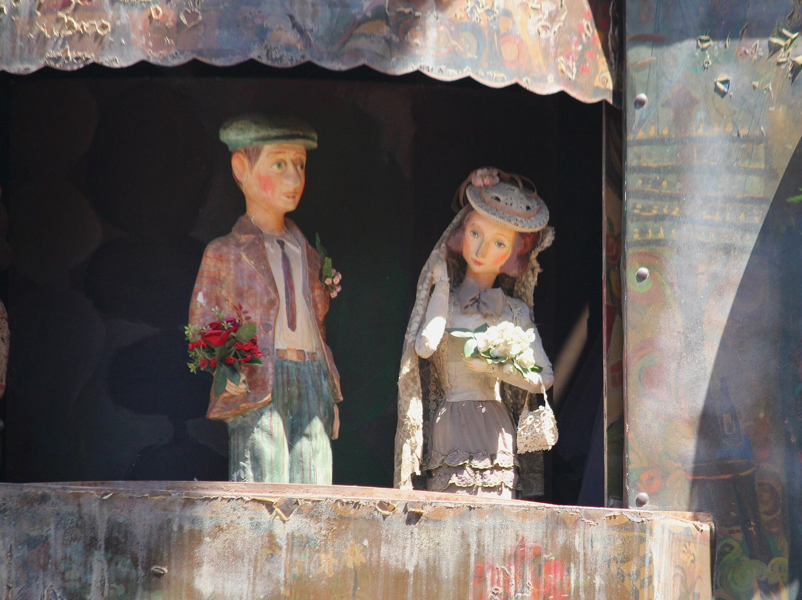 The bride and groom puppets on the clock tower stage during the wedding scene of the Circle of Life show