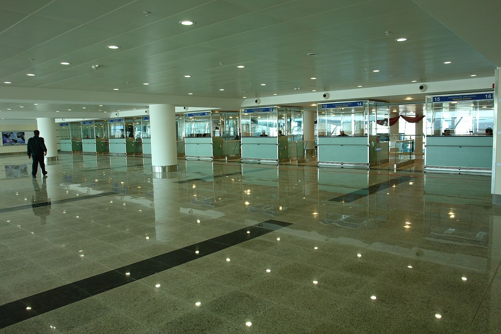 Passport control booths in the arrivals hall at Tbilisi International Airport