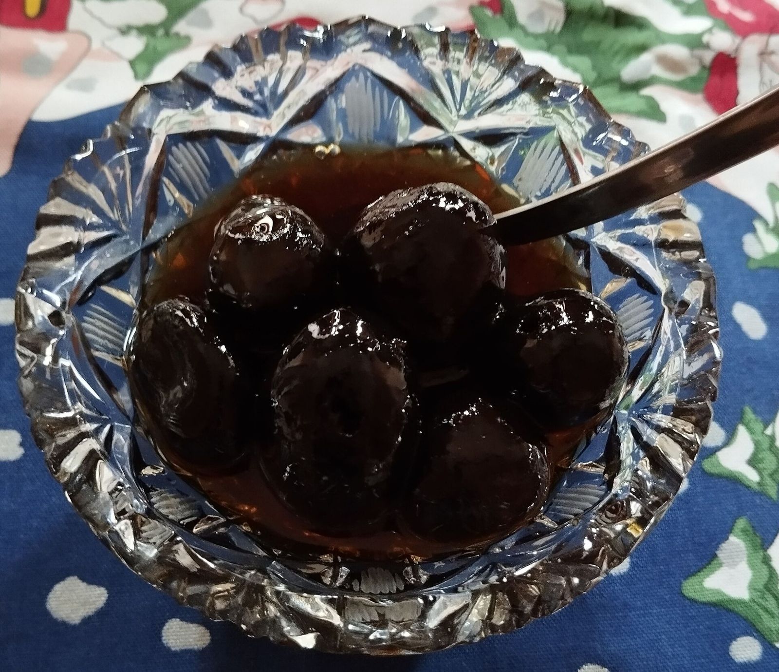 Green walnut muraba, whole walnuts in dark syrup, in a cut-glass dish