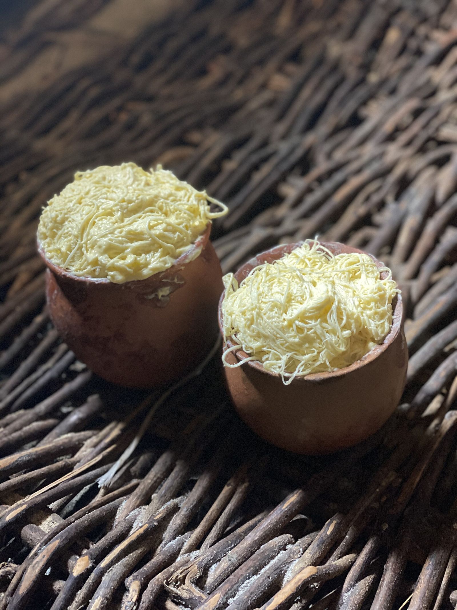 Tenili cheese pulled into fine threads, packed into two small clay pots
