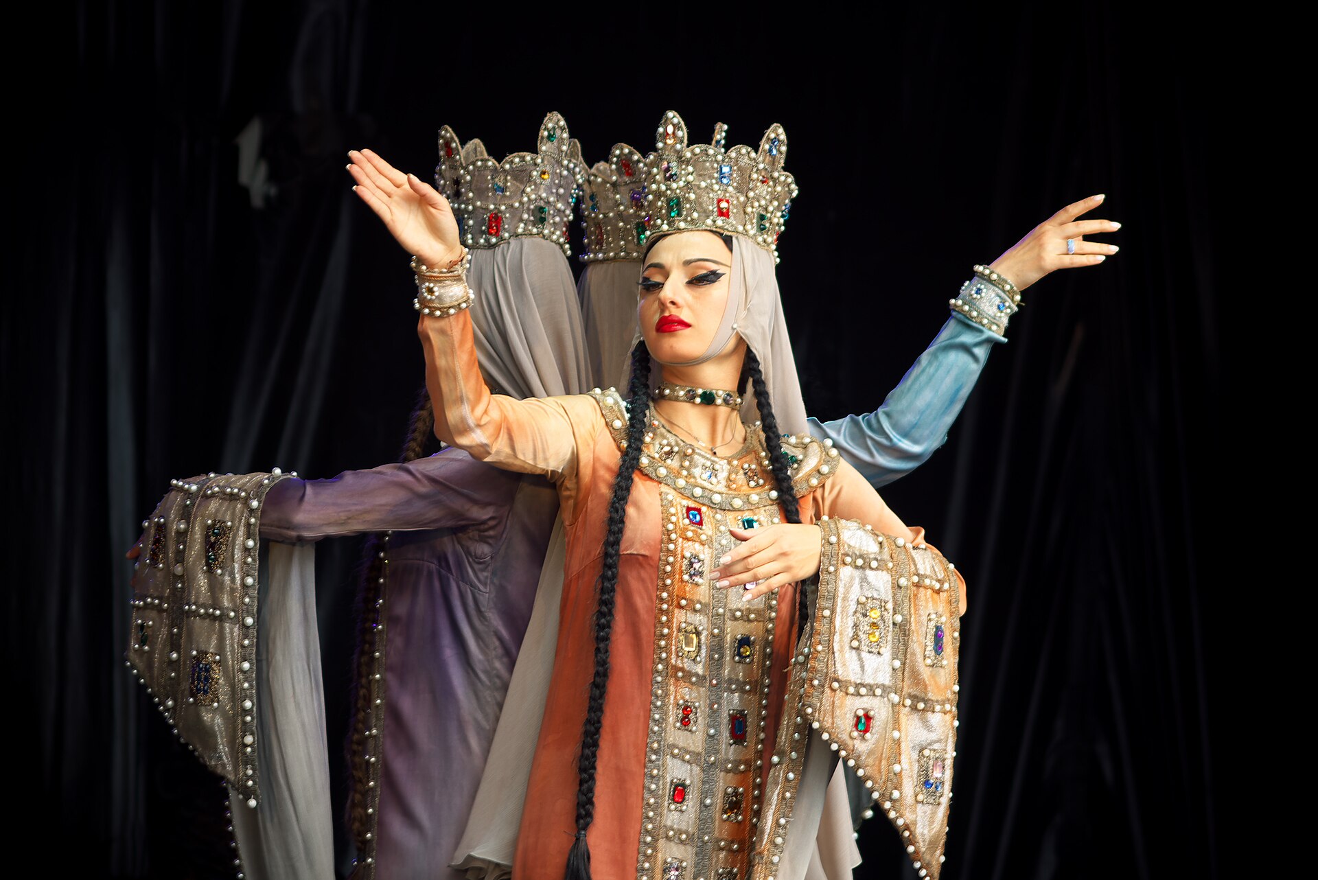 Sukhishvili dancers in jeweled crowns and long robes performing Samaia