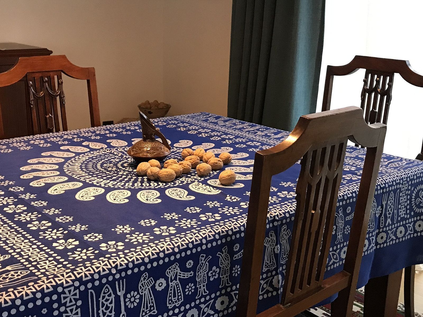 A lurji supra, the Georgian blue tablecloth printed with white figures and patterns, spread over a dining table