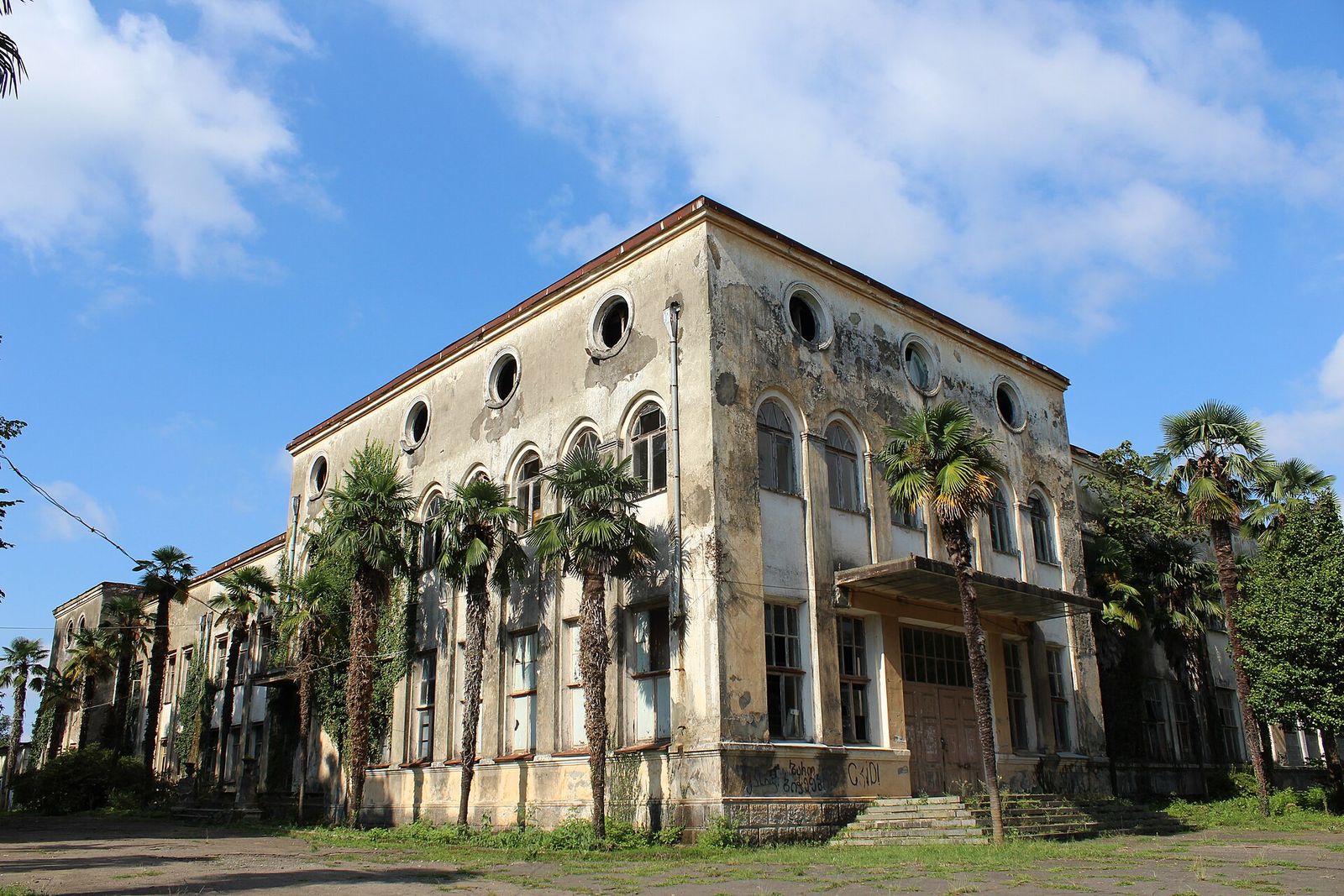 The former tea factory and research institute office in Anaseuli, Guria, a peeling two-story building behind palm trees