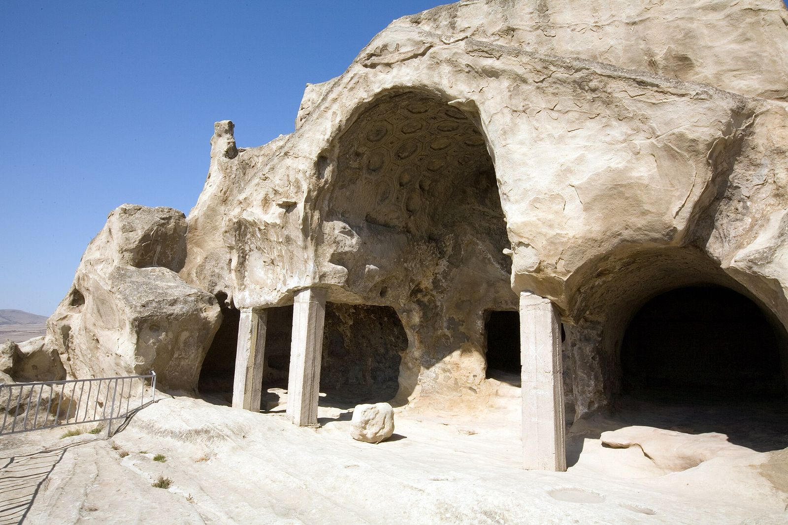 The Caisson Hall at Uplistsikhe, its arched rock ceiling carved into rows of eight-sided coffers, held up today by modern support pillars