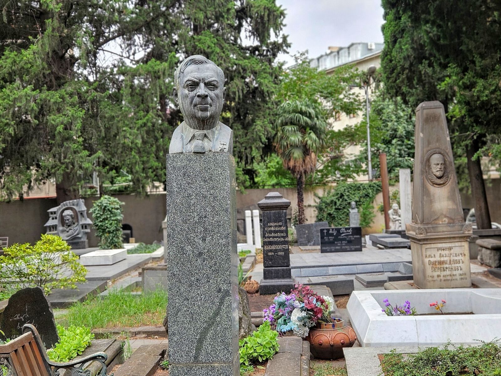 Busts and carved gravestones among the trees in the north-west corner of the Didube Pantheon, Tbilisi