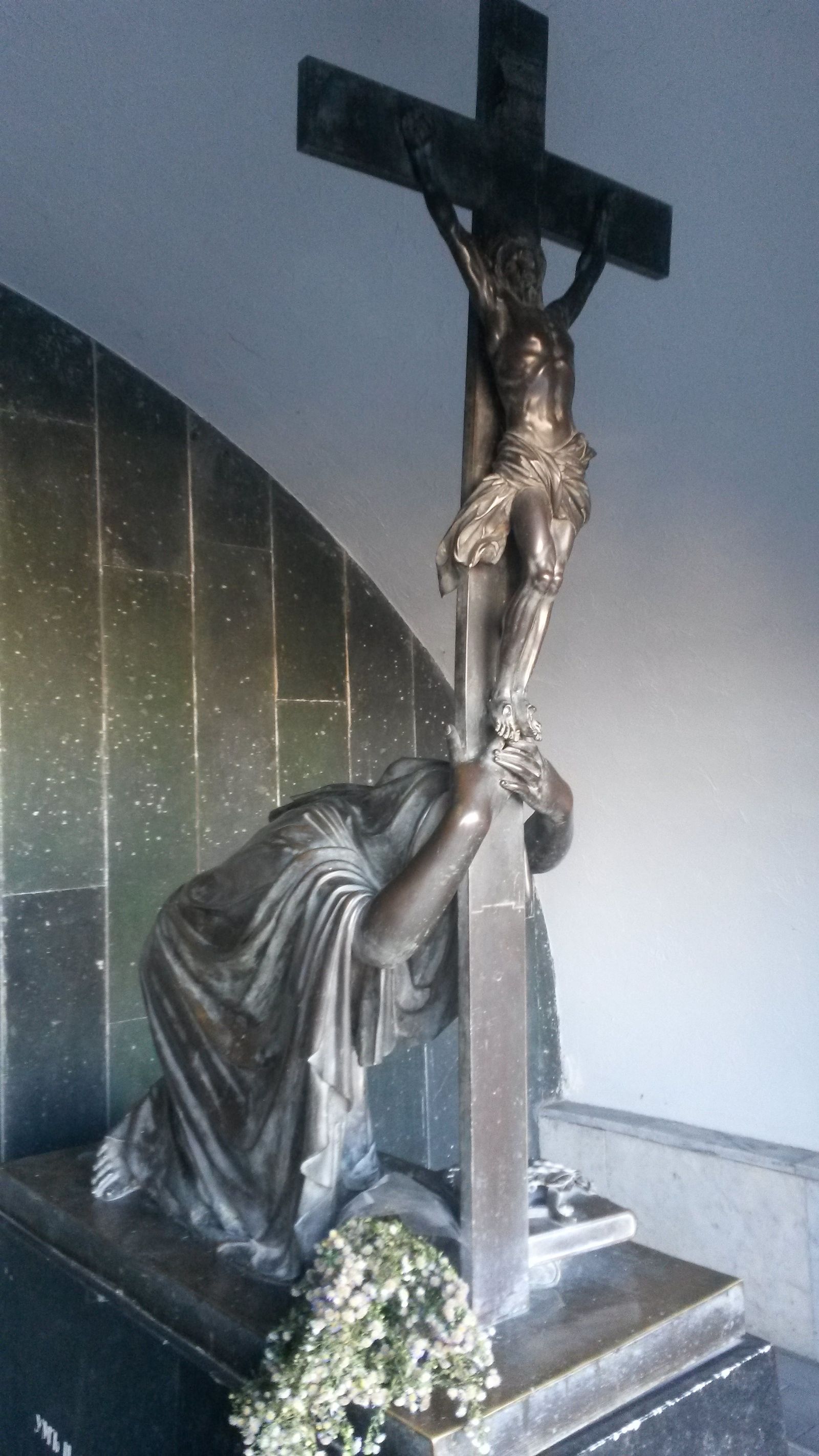 The bronze widow clinging to a crucifix over Alexander Griboyedov's tomb in its grotto at the Mtatsminda Pantheon