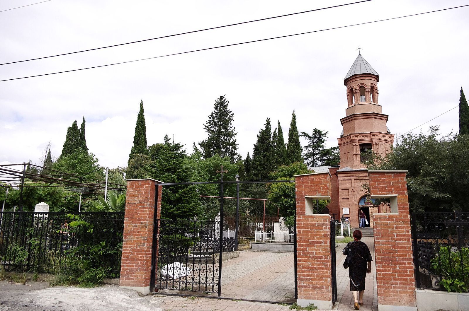 The brick gate of Kukia Cemetery in Tbilisi, with the bell tower of the Church of St Nino behind it