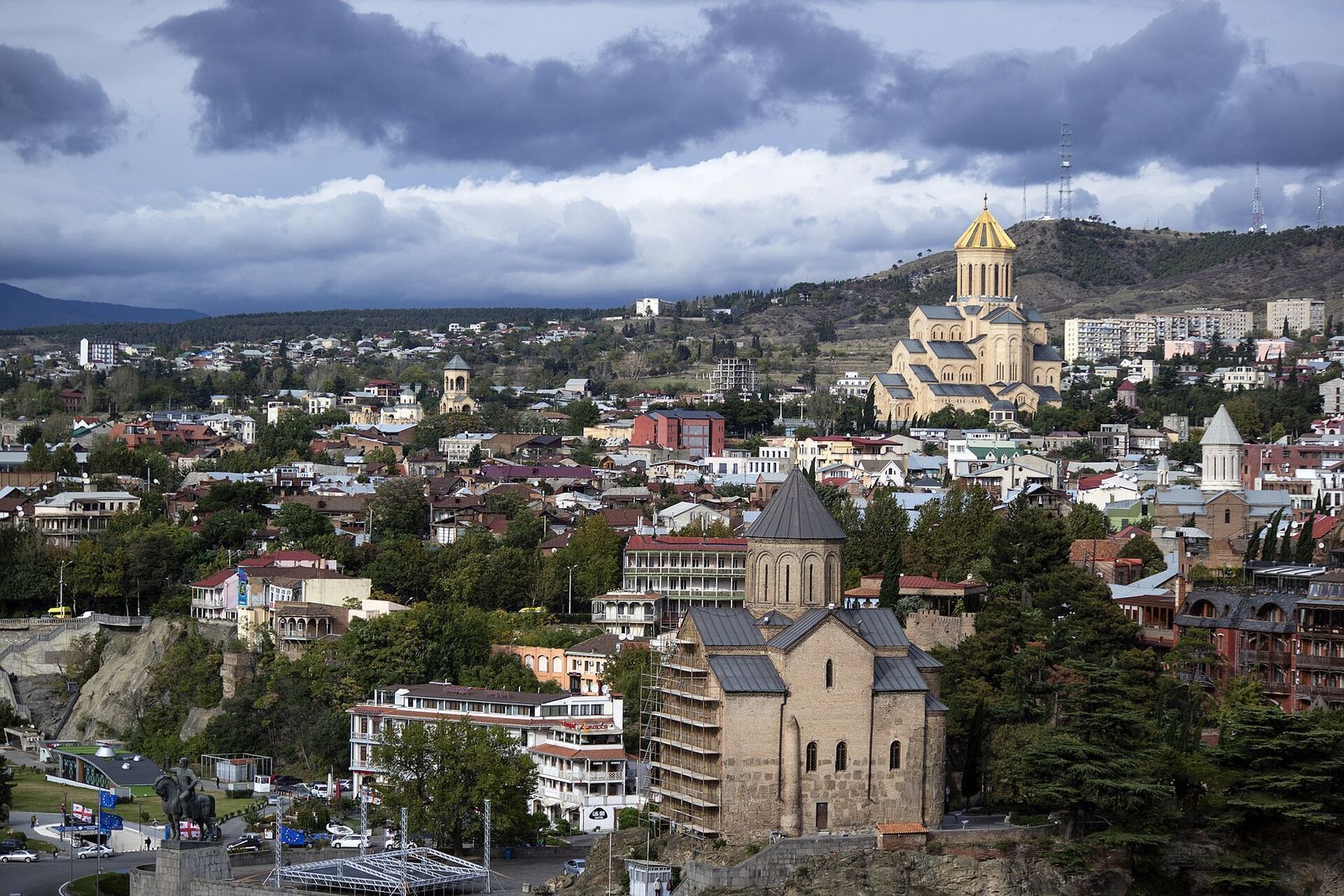 Sameba cathedral's gold dome on Elia Hill above the houses of Avlabari, with Metekhi Church in the foreground