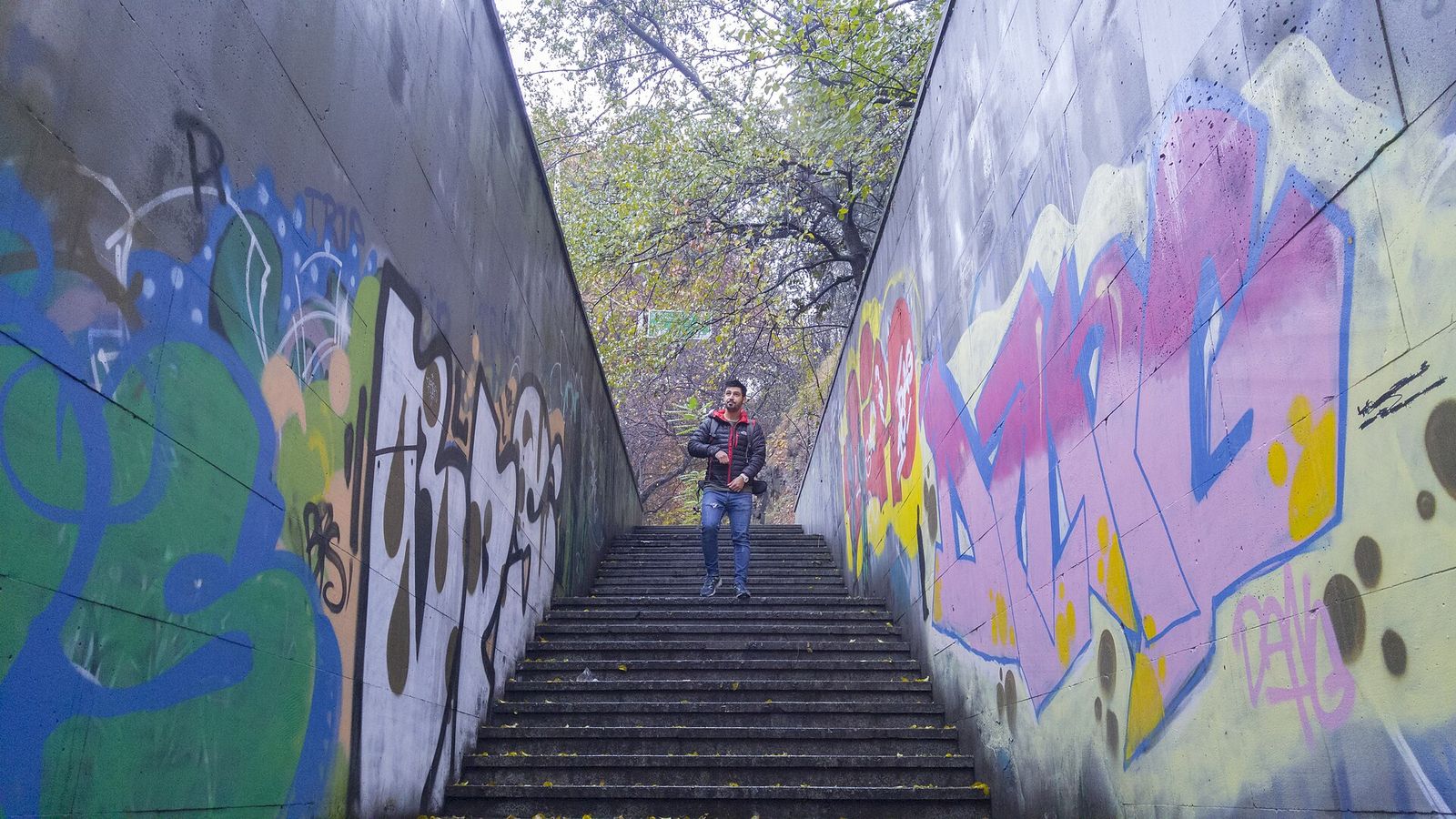 Stairs leading down into a graffiti-covered pedestrian underpass at Heroes' Square in Tbilisi