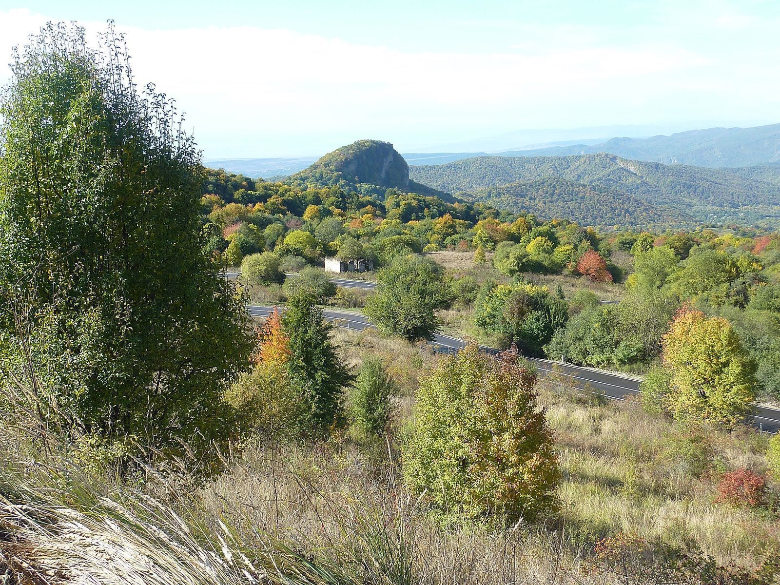The road over the Gombori Pass winding through autumn forest between Tbilisi and Telavi