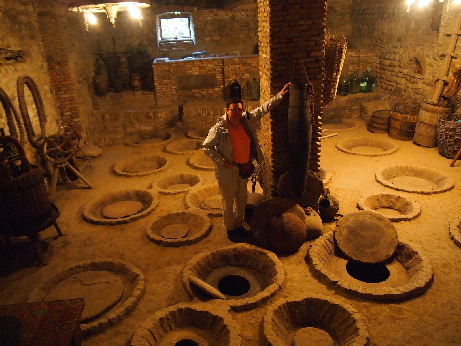 The rims of qvevri, clay wine jars buried in the floor of a winery cellar in Kakheti