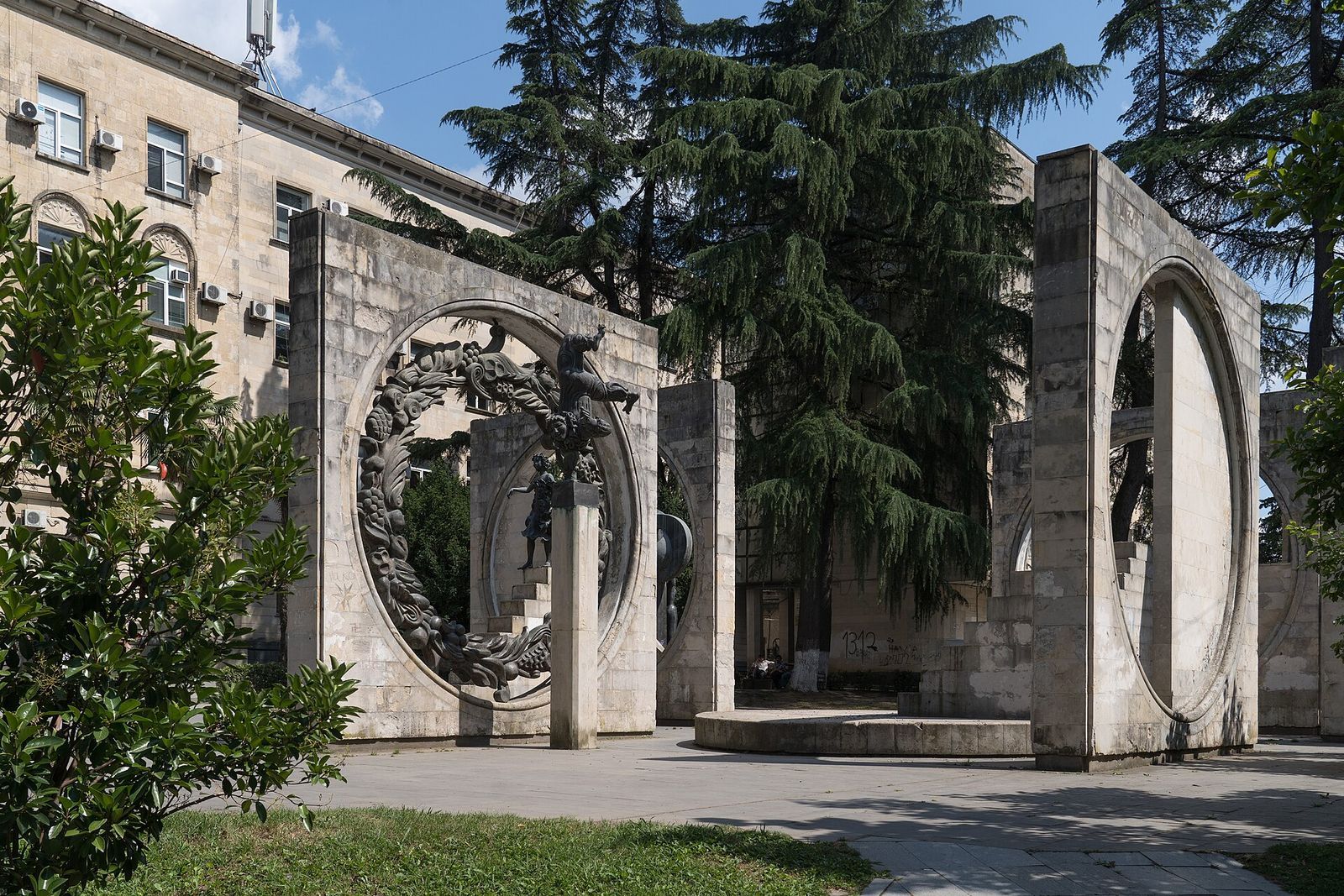 The Glory to Labor monument in Kutaisi, wrought-iron sculpture set inside tall stone rings