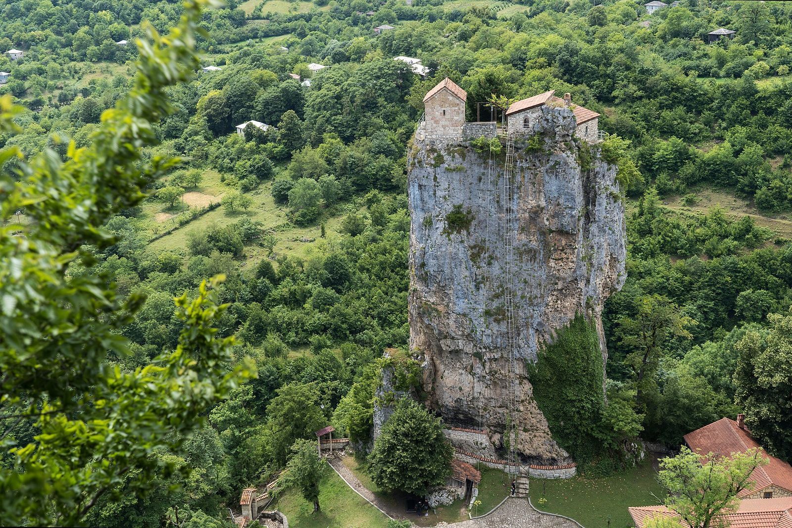 The Katskhi Pillar, a limestone column with a small church on its top, rising out of the forest