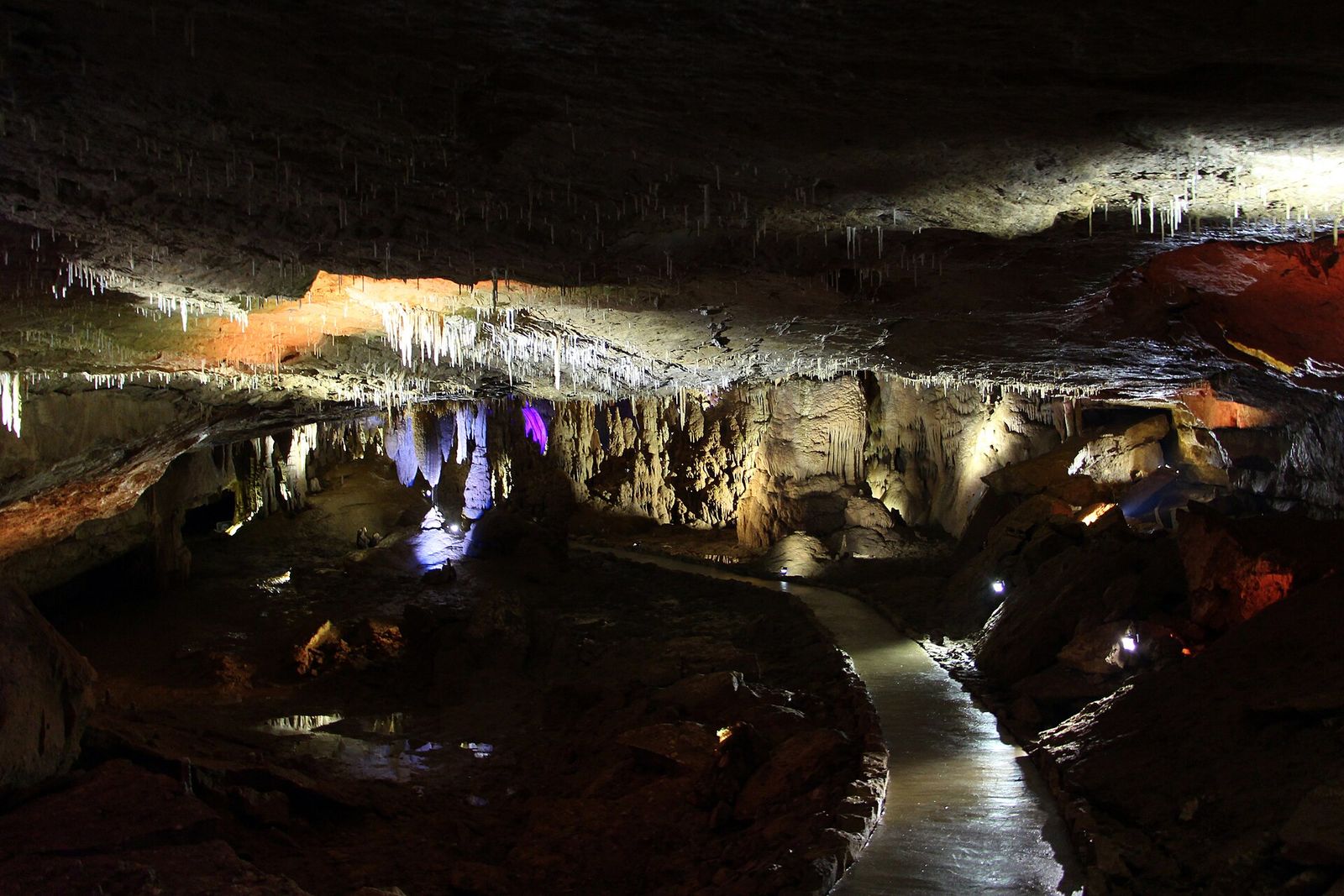 Lit stalactites above the walkway inside Prometheus Cave near Kutaisi