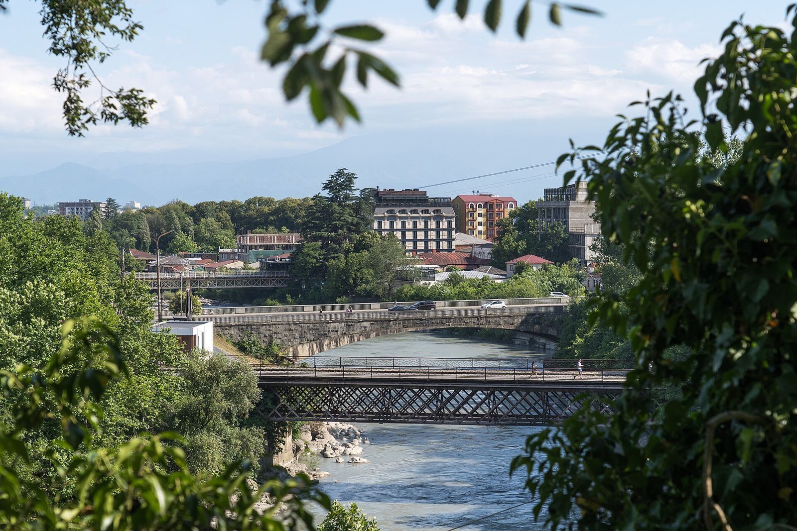 The old iron Red Bridge over the Rioni in Kutaisi, with another bridge and the city behind it
