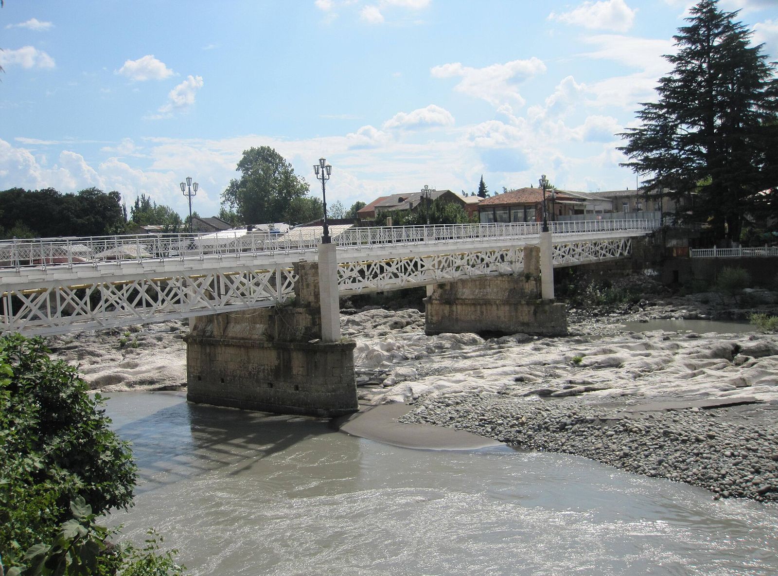 The White Bridge in Kutaisi, a pedestrian bridge with white railings over the rocky bed of the Rioni