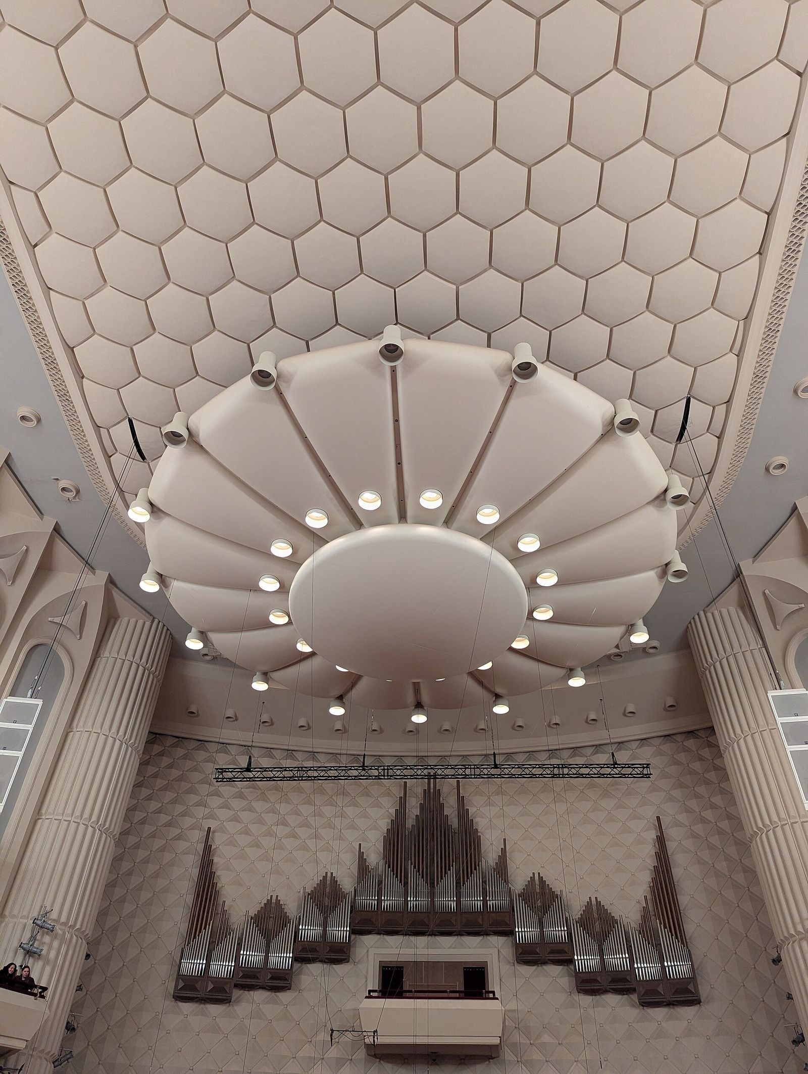 The main hall of the Kakhidze Music Center in Tbilisi with its honeycomb ceiling, round chandelier and pipe organ