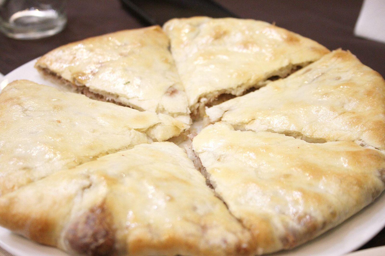 Lobiani, the Georgian bean-filled bread, cut into wedges on a plate