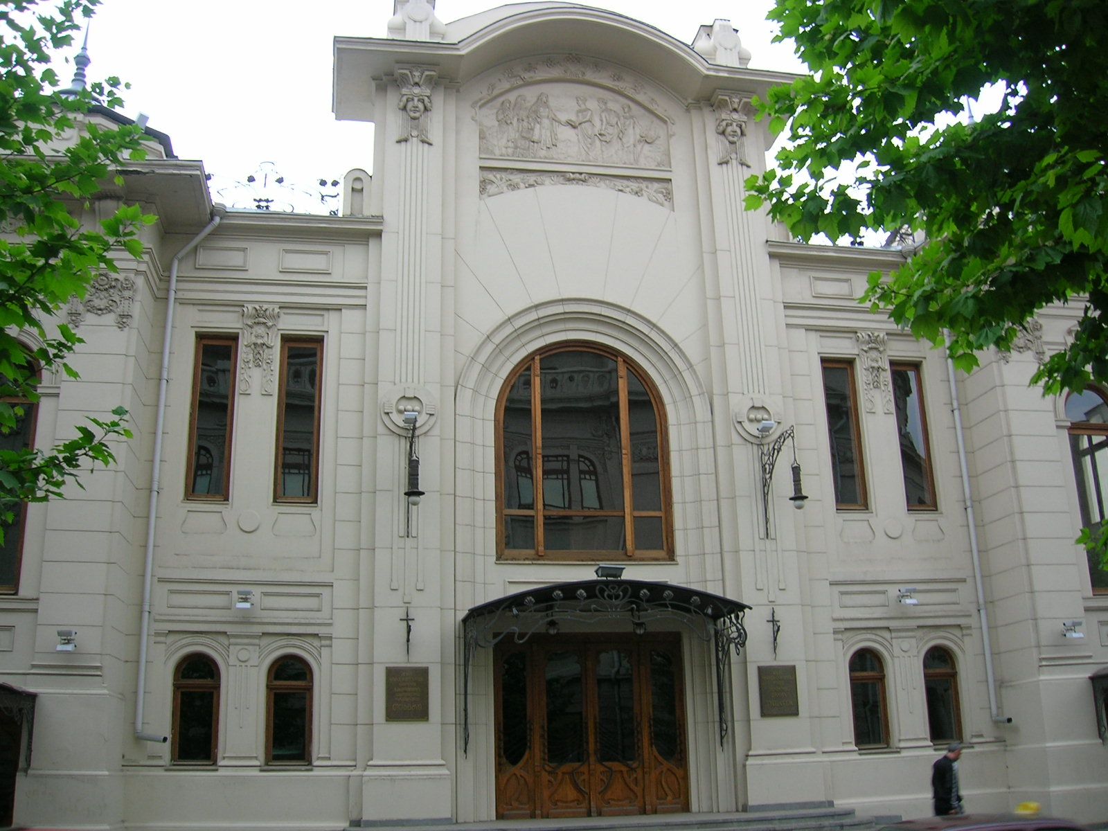 The Art Nouveau facade of the Marjanishvili Theatre in Tbilisi, with a tall arched window and a relief panel above the entrance