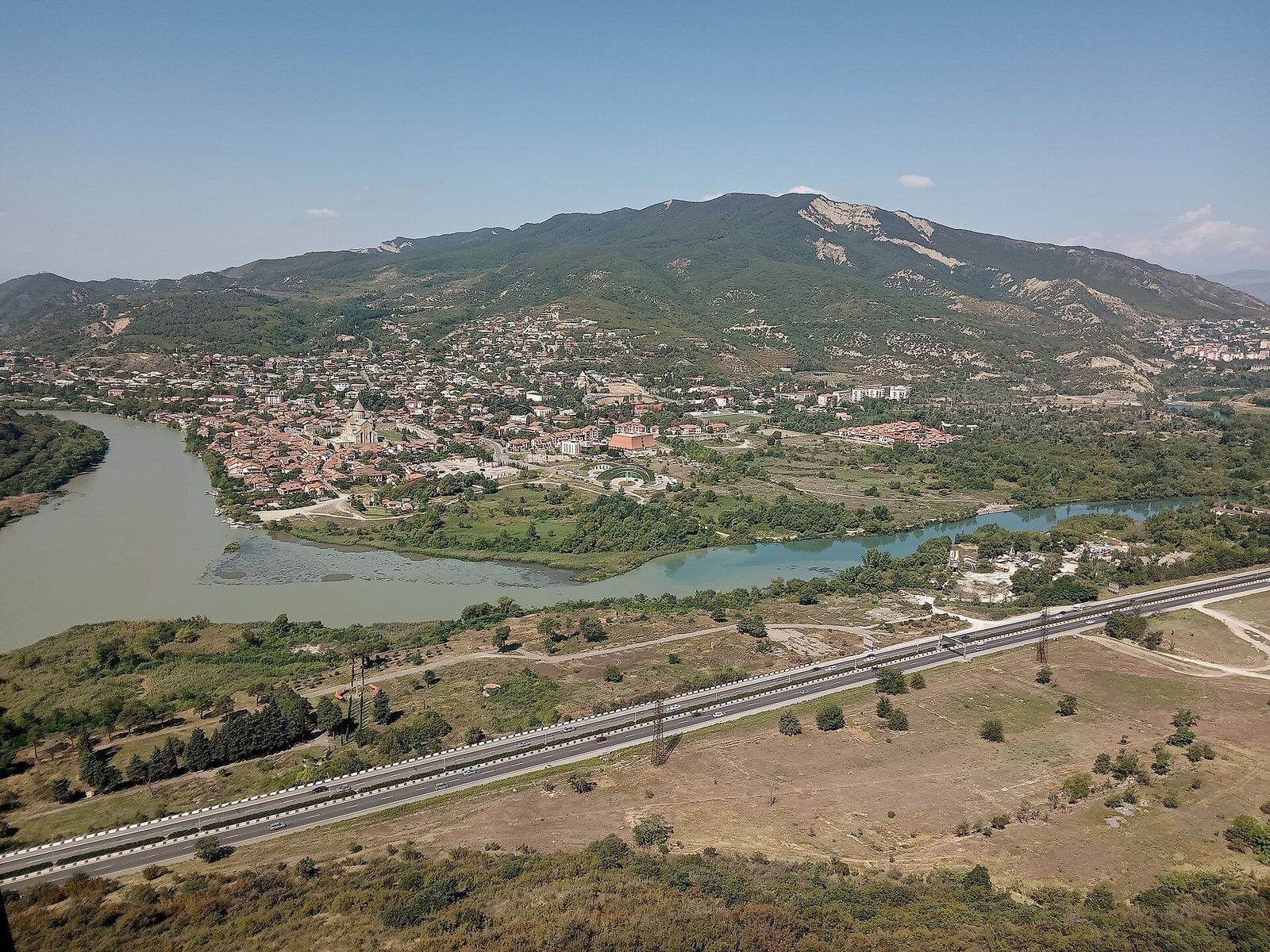 The blue Aragvi and the brown Mtkvari meeting below Jvari, with the town of Mtskheta and its cathedral on the far bank
