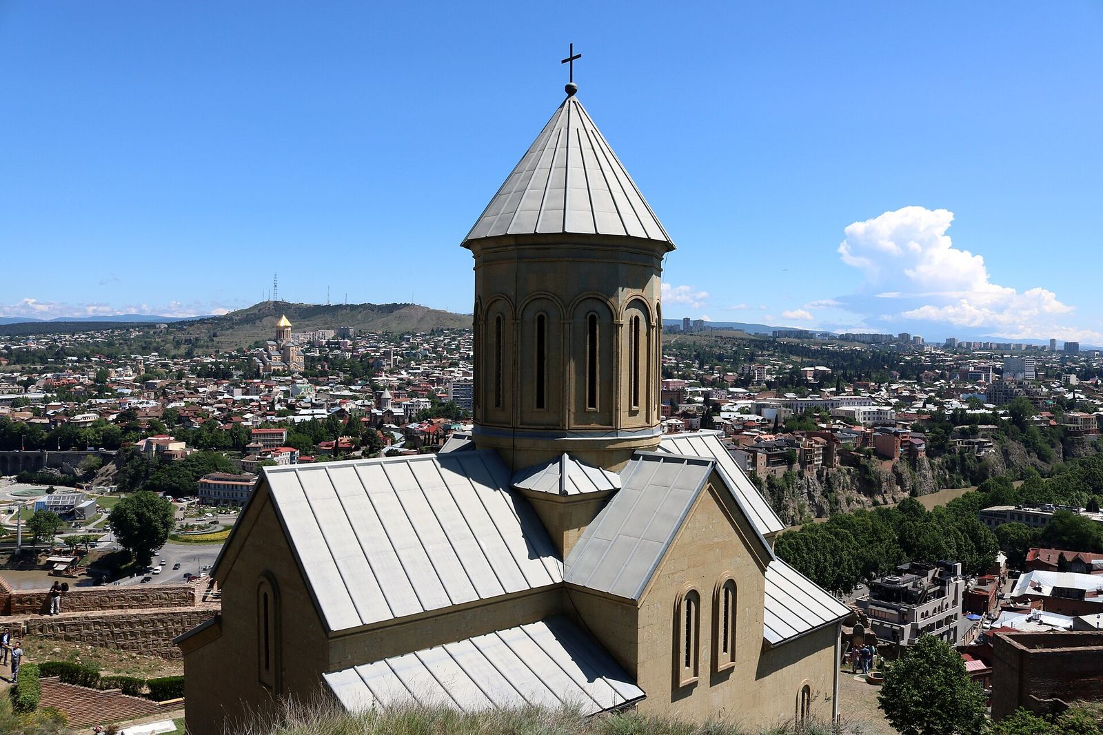 St Nicholas Church inside Narikala's lower walls, its conical dome above Old Tbilisi with Sameba cathedral on the hill behind