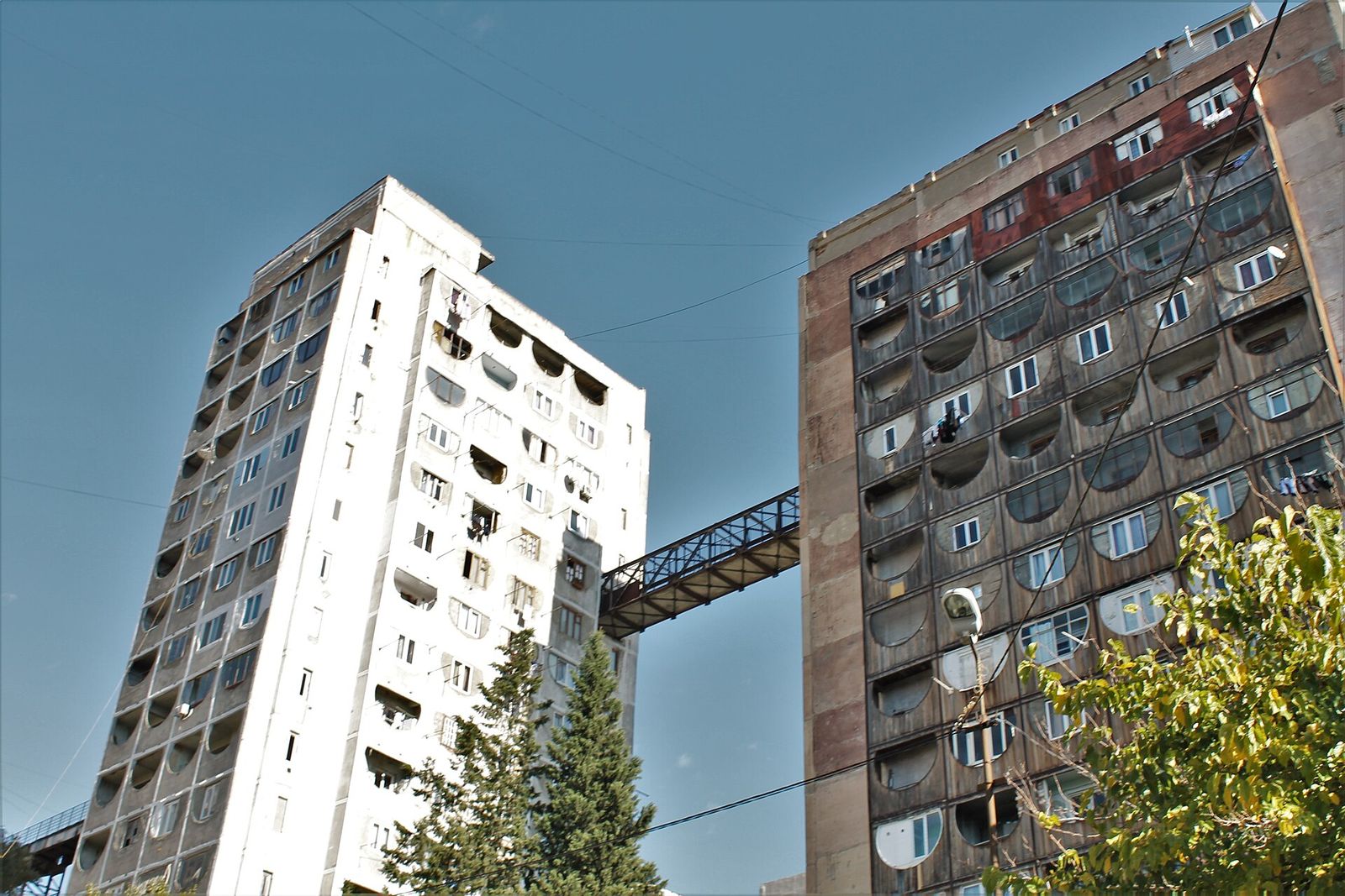 Two Soviet apartment towers of the Nutsubidze Skybridge in Saburtalo, joined high up by a metal bridge
