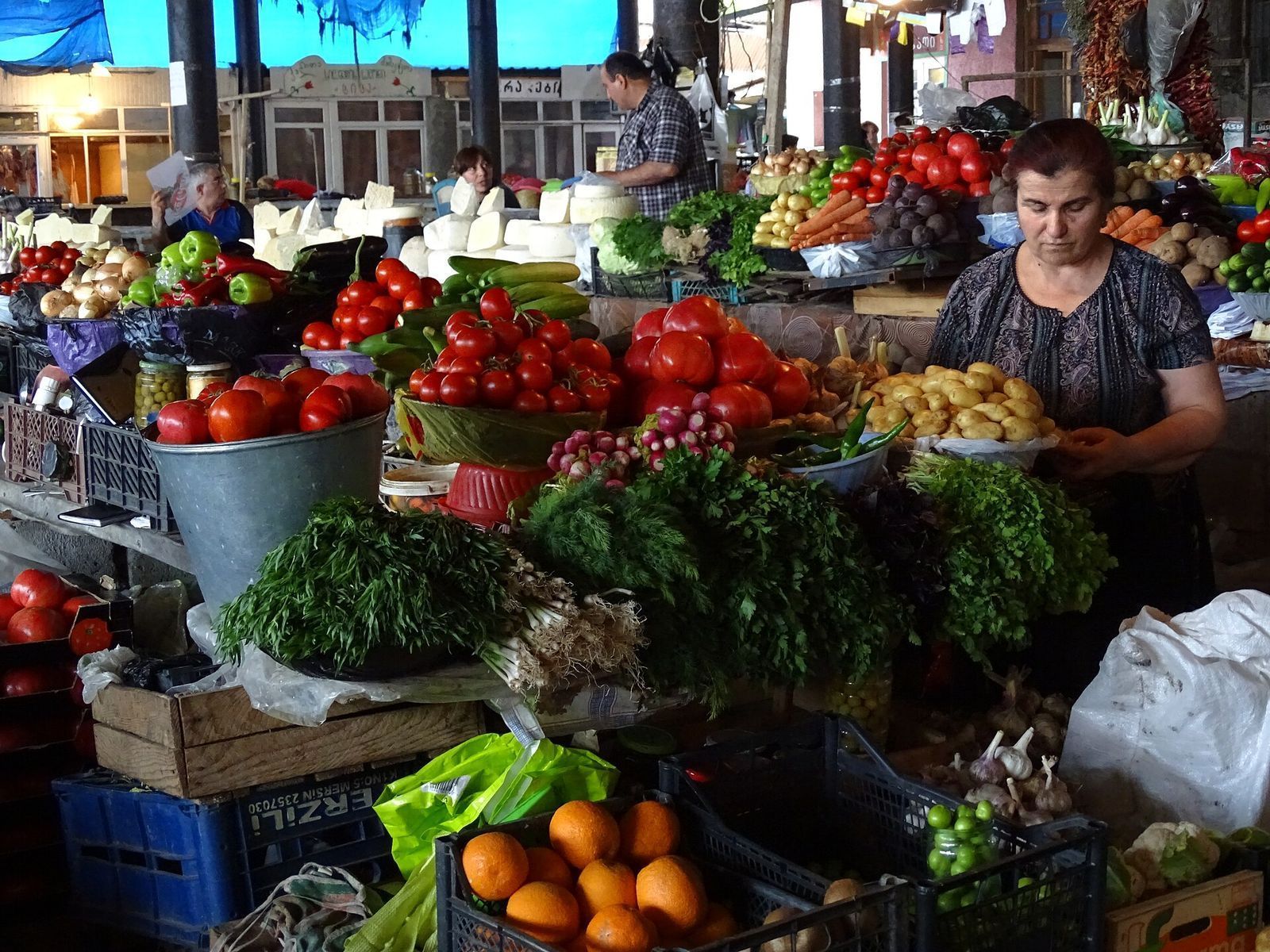 Stalls of tomatoes, herbs, potatoes and cheese at the market in Telavi
