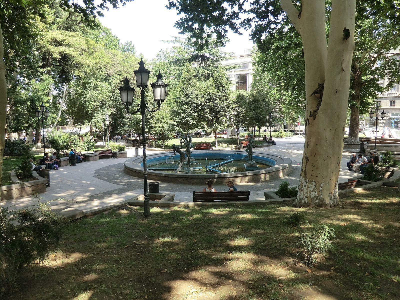 The fountain with bronze figures, benches and plane trees in the garden on Orbeliani Square, Tbilisi