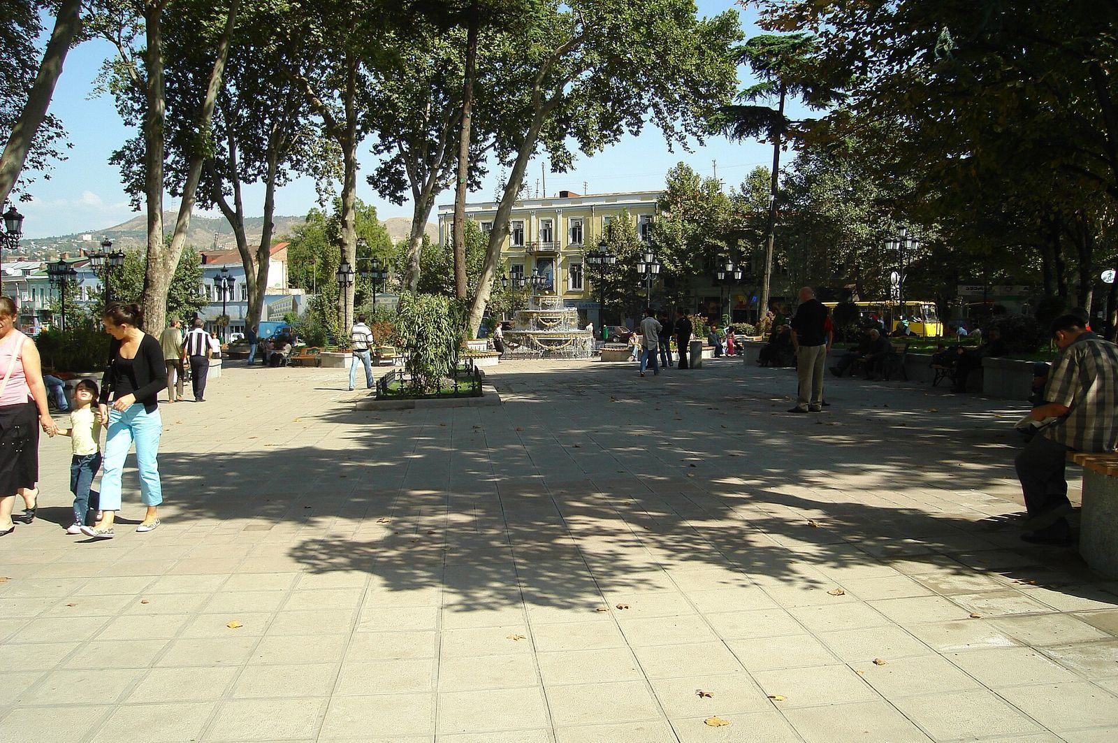 Plane trees, benches and the fountain in Pushkin Garden on the corner of Freedom Square, Tbilisi